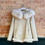 Front of ivory women’s sheepskin biker jacket with plush collar and belted hem