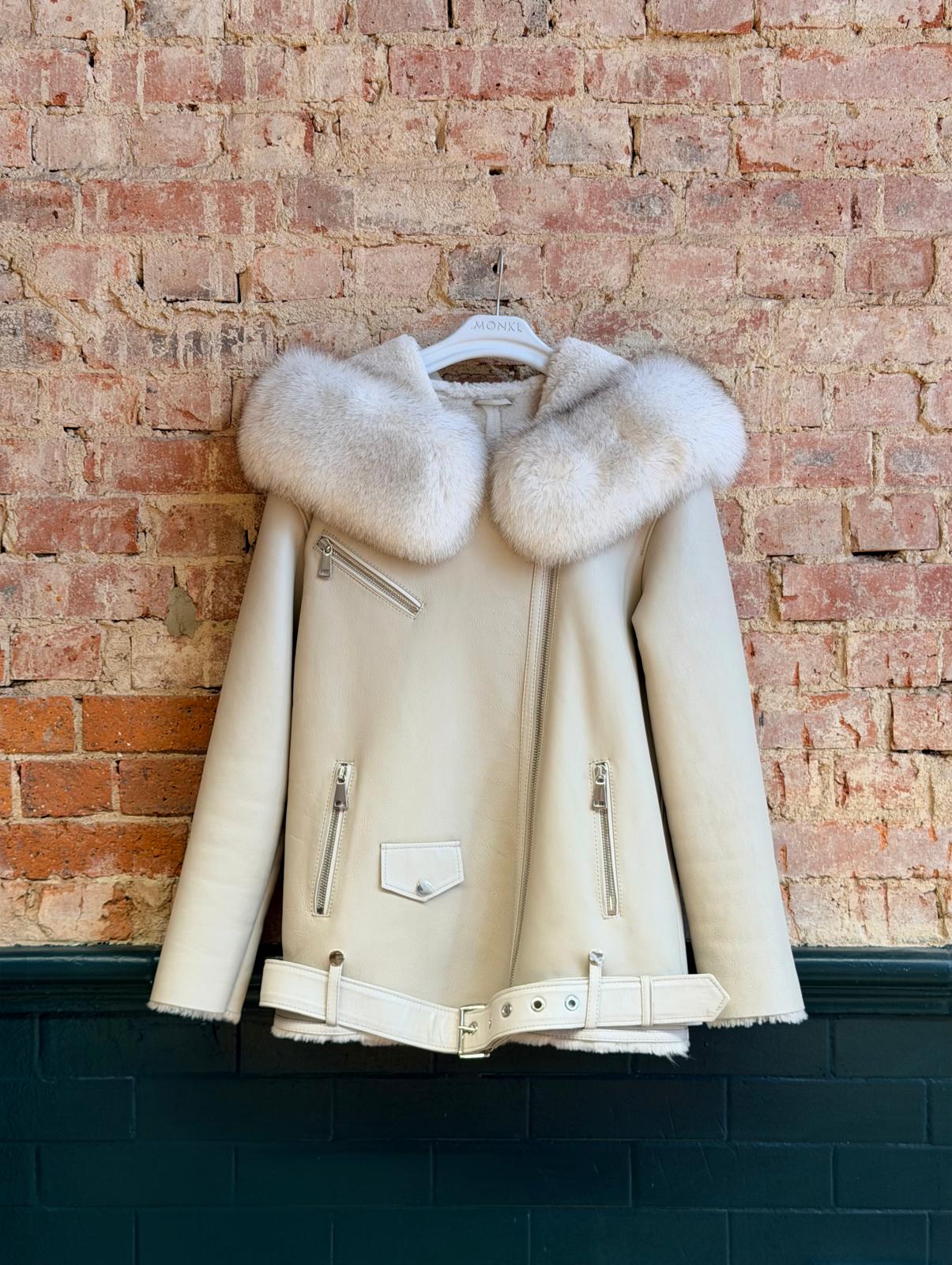 Front of ivory women’s sheepskin biker jacket with plush collar and belted hem